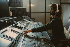 Side View Of Concentrated Sound Producer Working At Studio Stock Photo - Download Image Now - iStock