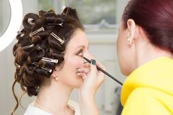 Premium Photo | The stylist does the girl's hair and makeup