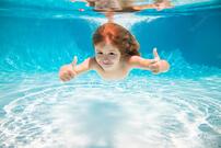 Premium Photo | Kid swim underwater in pool child boy swimming under water with thumbs up