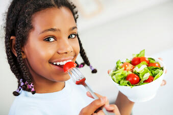 Little Girl Eating Vegetable Salad Stock Photo - Download Image Now - Eating, Child, Salad - iStock