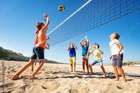 Boys and girls playing volleyball on the beach фотография Stock | Adobe Stock