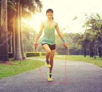 Fitness woman skipping rope Stock Photo by ©lzf 126074716