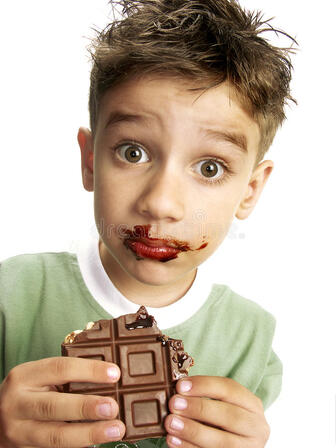 Cute boy eating chocolate stock image. Image of sugar - 16971583
