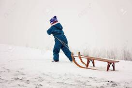 Boy Pulling His Sleigh Up The Hill Stock Photo, Picture And Royalty Free Image. Image 18693119.