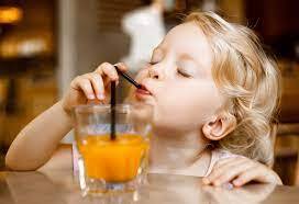 Premium Photo | Beautiful blonde girl sitting at the table in the cafe outdoors drinking juice and eating desserts