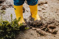 Child Legs in Yellow Muddy Rubber Boots on Wet Mud. Baby Playing with Dirt at Rainy Weather Stock Photo - Image of playing, galoshes: 148359094